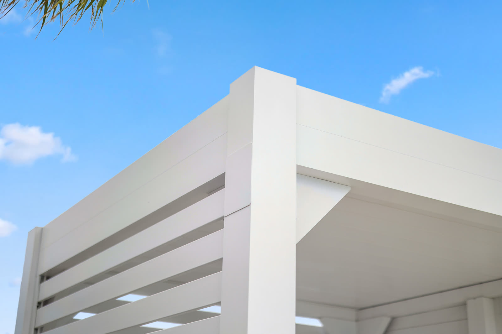 Azenco R-BLADE pergola beside a pool deck. Manufacturer-network installation photo, not a CCSI project.